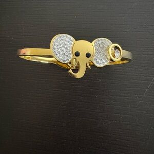 Newei hinged bracelet gold plated with elephant design. New.